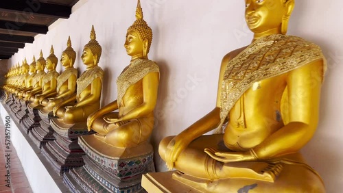 Many ancient golden Buddha statues lined up in Wat Phutthaisawan, Ayutthaya, Thailand, is a symbol of Ayutthaya Province. photo