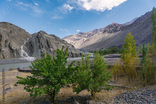 beautiful landscape with green trees and blue sky  mountains in the background at Ladakh  in the Indian Himalayas.