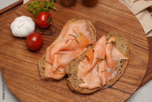 raw smoked salmon on wooden board for breakfast