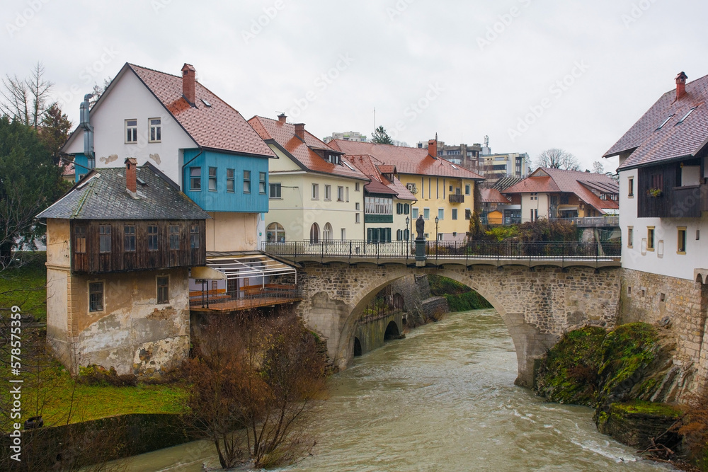 A wet December day in Skofja Loka in Gorenjska, Slovenia. The Capuchin Bridge crossing the Selska Sora river as it flows through the historic centre