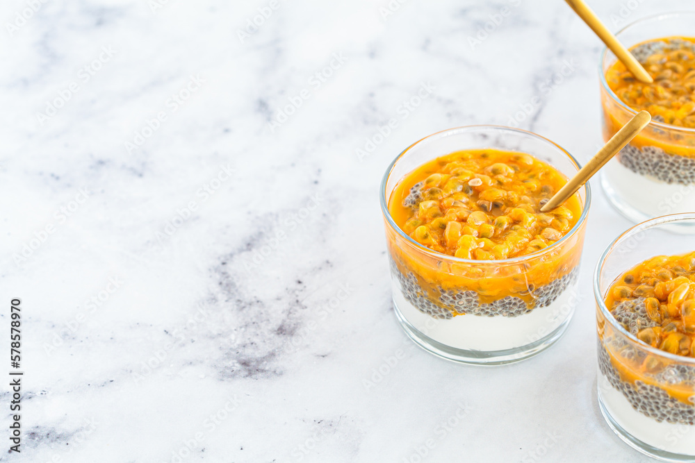 Chia pudding with passion fruit and coconut yogurt in glass. Healthy vegan recipe. Chia pudding with passion fruit and coconut yogurt in glass. Healthy vegan recipe.