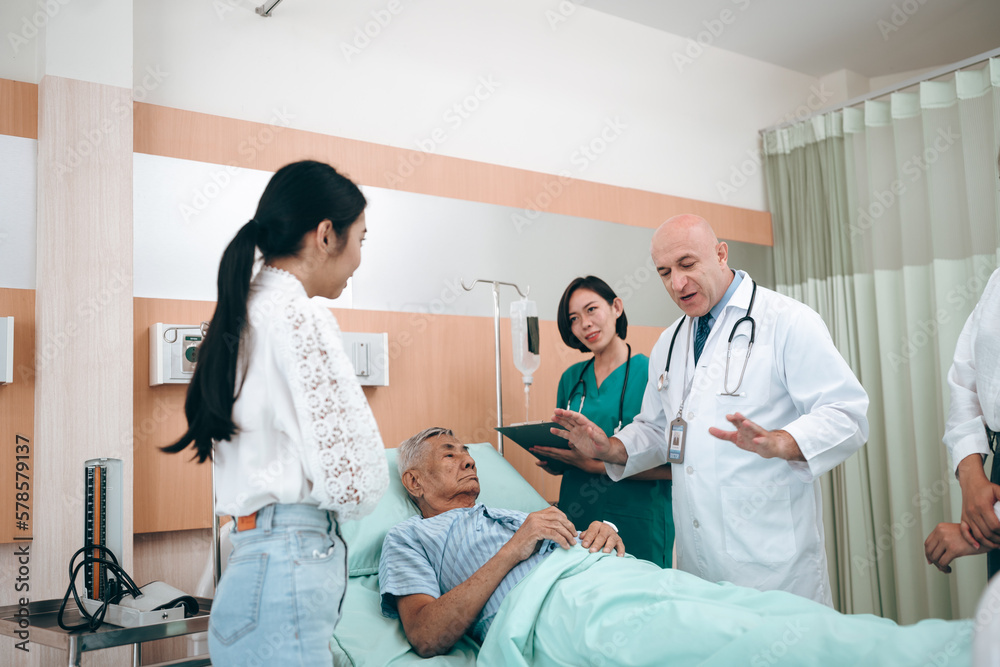 Fototapeta premium professional doctor standing by explain the treatment information via male elderly patient lying in bed in private hospital sickroom. The treatment program is suitable for people to socialize elderly