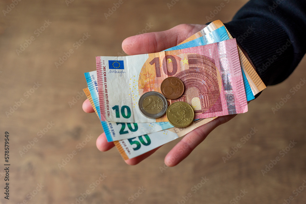 Euro money in hand banknotes and coins.