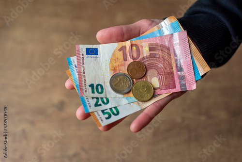 Obraz na płótnie Euro money in hand banknotes and coins. w salonie