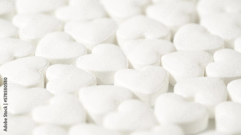 Macro white heart shape drugs, closeup medical pills rotating, medicine concept Macro white heart shape drugs, closeup medical pills rotating, medicine concept