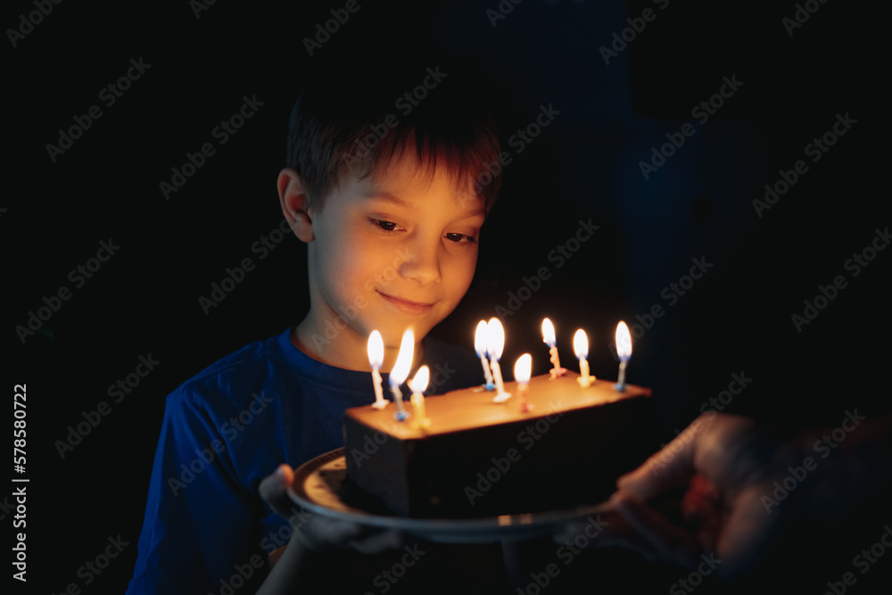 little cute caucasian boy making a wish before puffing out a candle on cake on his 9 birthday little cute caucasian boy making a wish before puffing out a candle on cake on his 9 birthday