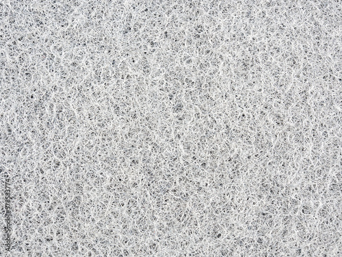 Fotografie white non-woven rough abrasive pad texture and background.