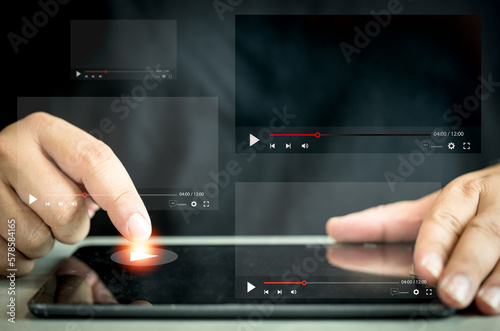 Man watching a live stream by tablet. Online live stream window. Video streaming on internet concept. Live digital stream multimedia player. Online content scrolling videos online followed