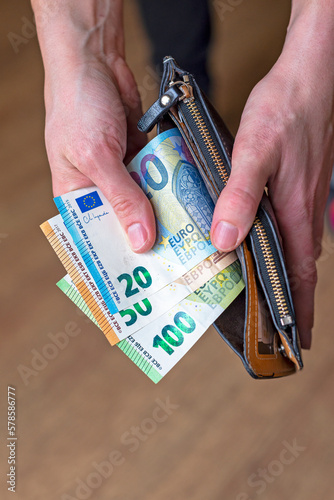 Obraz na płótnie Euro money taken out of a wallet by a person. w salonie