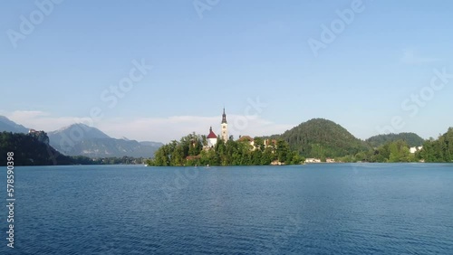 Lake Bled Island Church, Aerial Drone Above Blue Water, People Paddling, Julian Alps, European Travel and Tourism Summer Destination photo