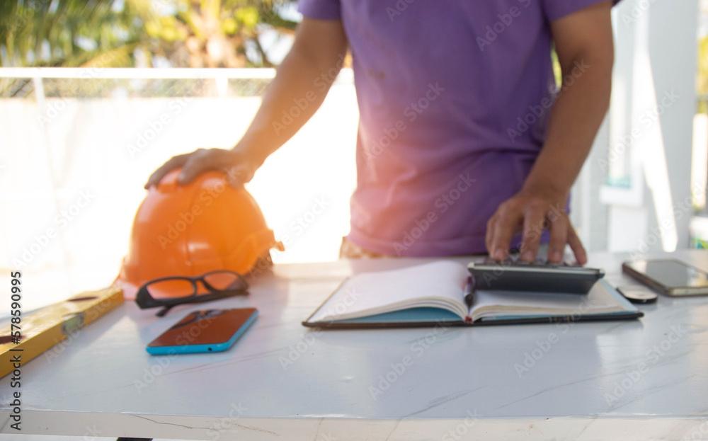Engineer and Architect planing and discuss at Construction Site with blueprint