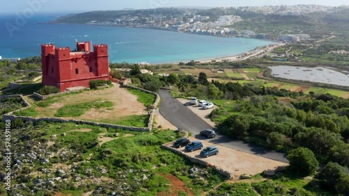 Car Driving On The Road Going To The Red Tower In Mellieħa, Malta. Aerial Drone Shot photo