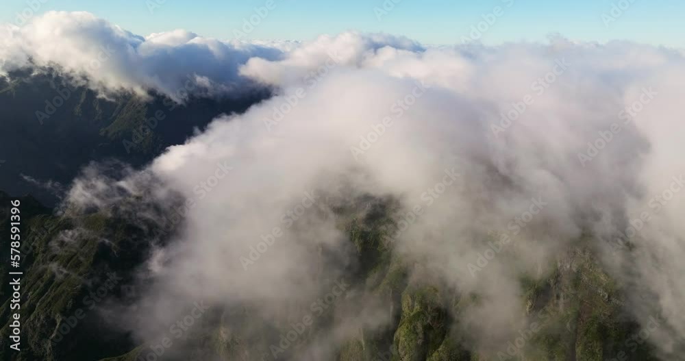 Cloudscape Engulfing Mountain Peaks Of Pico do Arieiro In Madeira Island, Portugal. Aerial Shot Cloudscape Engulfing Mountain Peaks Of Pico do Arieiro In Madeira Island, Portugal. Aerial Shot