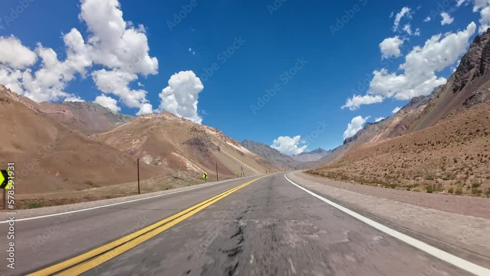 POV shot driving through the dry vast scenic mountain range in Mendoza, Argentina POV shot driving through the dry vast scenic mountain range in Mendoza, Argentina