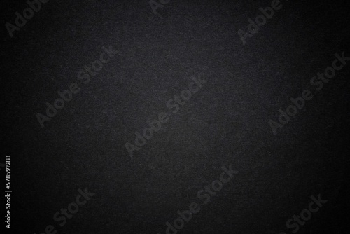 Black dark background with light copyspace in middle. Toned grunge retro vintage wallpaper with cardboard texture surface. Mockup design for dark arts. Blackout Tuesday concept. protest.