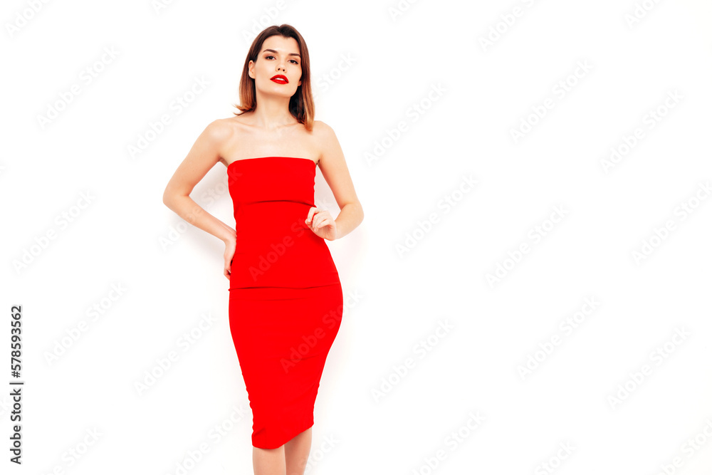 Young beautiful smiling female in trendy summer red evening dress. Sexy carefree brunette woman posing in studio, isolated on white. Positive model with evening makeup. Cheerful and happy. red lips Young beautiful smiling female in trendy summer red evening dress. Sexy carefree brunette woman posing in studio, isolated on white. Positive model with evening makeup. Cheerful and happy. red lips