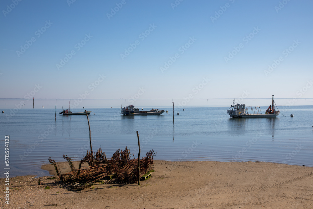 oysters farm coast and boat at low tide in lege village of Arcachon bay cap ferret