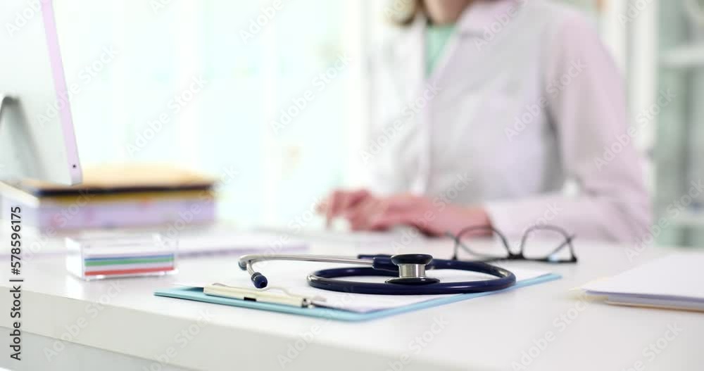 Stethoscope lies on table doctor communicates with patient remotely Stethoscope lies on table doctor communicates with patient remotely