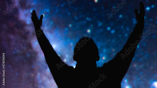 Silhouette of a man with Milky Way starry skies.