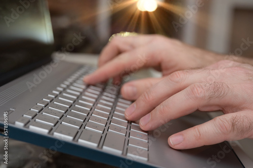 Hands on the keyboard. Work on the computer. 