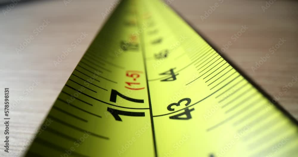 Yellow steel construction tape close-up. Measuring length and distance ruler Yellow steel construction tape close-up. Measuring length and distance ruler