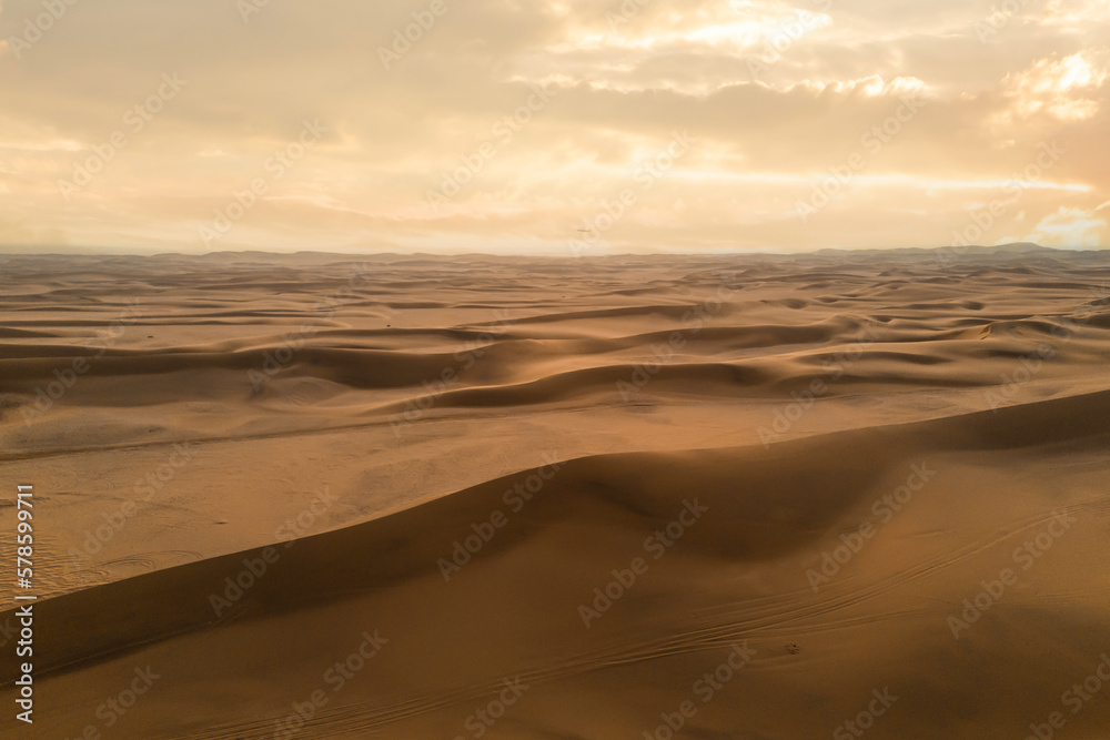 Aerial top view of Namib Desert Safari with sand dune in Namibia, South Africa. Natural landscape background at sunset. Famous tourist attraction. Sand in Grand Canyon Aerial top view of Namib Desert Safari with sand dune in Namibia, South Africa. Natural landscape background at sunset. Famous tourist attraction. Sand in Grand Canyon