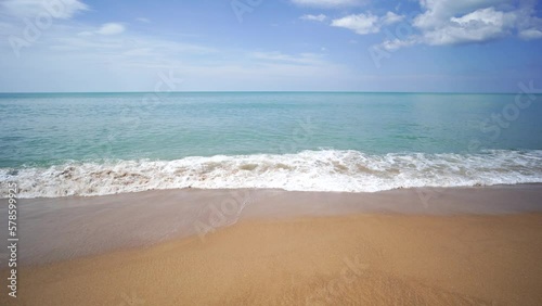 Landscape waves nature splashes beach sunlight.Blue sea waves and sky on sand famous beach.clean sea white clouds soft daylight.	