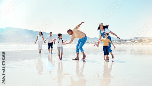 Family, beach and parents play with children for bonding, quality time and adventure together. Travel, freedom and happy mom, dad and kids enjoy summer holiday, vacation and relax on weekend by sea #578602929