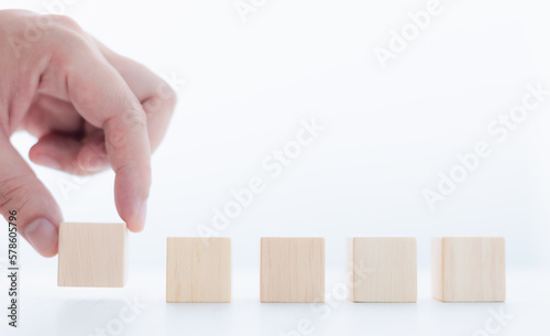 Businessman lined up wooden blocks free space to work