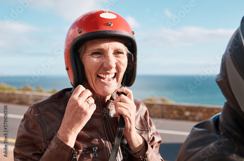 Summer, senior woman and helmet on road, happiness and quality time on break, relax and vacation. Mature female, old lady and safety for motor bike ride, smile and cheerful on holiday and joyful