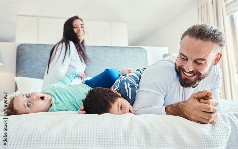 Obraz premium Happiness, smile and family being playful in the bedroom together of their modern house. Happy, love and excited children having fun, playing and bonding with their parents on the bed at their home.