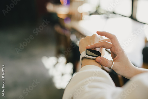 Woman uses a smart watch.