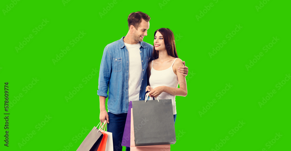 Love, holiday sales, shop, retail, consumer concept - happy couple with shopping bags, isolated green chroma key background. Love, holiday sales, shop, retail, consumer concept - happy couple with shopping bags, isolated green chroma key background.
