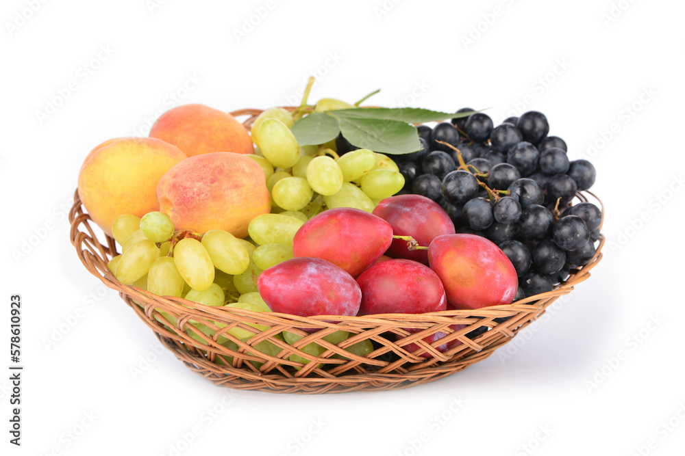 Ripe various fruits in a wicker plate isolated on white background Ripe various fruits in a wicker plate isolated on white background