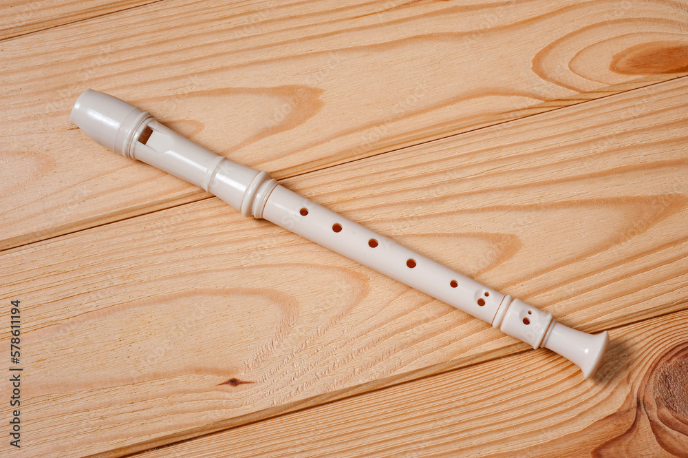 Block flute wind musical instrument photographed on a wooden surface. Block flute wind musical instrument photographed on a wooden surface.