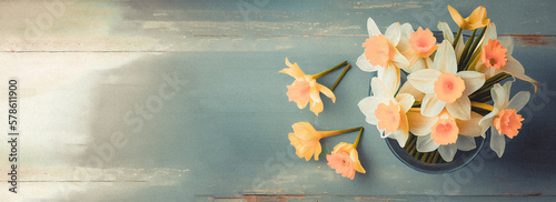 Spring easter background with top view of daffodils bouquet on light blue wooden table with copy space