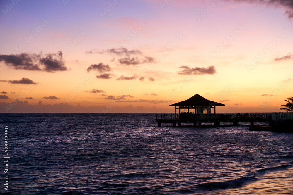 beautiful sunset on the sea with a pavilion in the foreground
