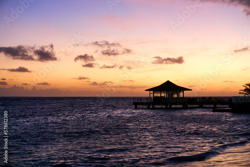 beautiful sunset on the sea with a pavilion in the foreground