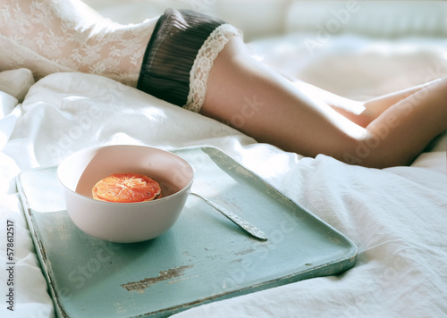 Grapefruit breakfast in bed with morning light photo