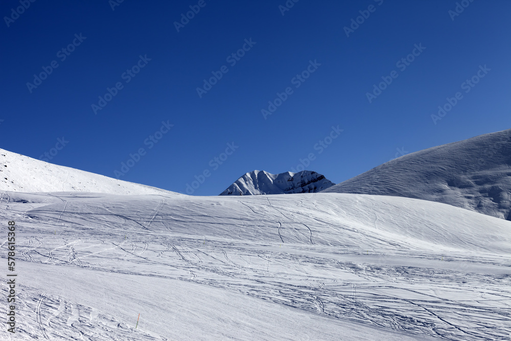 Ski slope in sun morning. Georgia, ski resort Gudauri. Caucasus Mountains.
