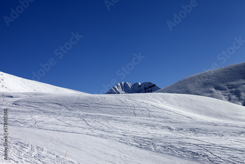 Ski slope in sun morning. Georgia, ski resort Gudauri. Caucasus Mountains.