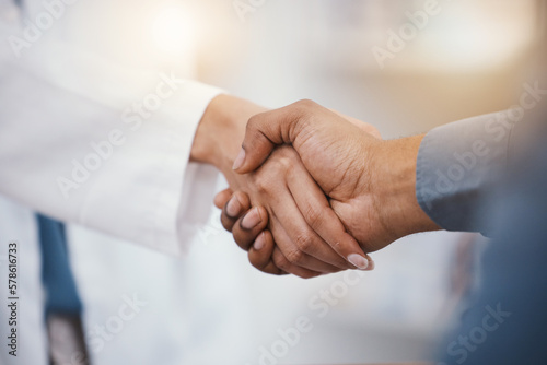 Doctor, patient and handshake in hospital thank you, welcome or greeting for medicine trust, help or medical consulting. Zoom, black man and shaking hands with pharmacy worker or healthcare employee