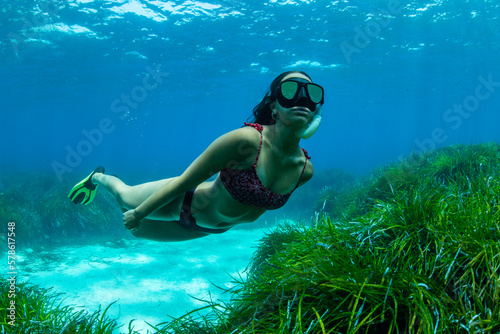 a girl explores the depths of the Mediterranean in freediving photo
