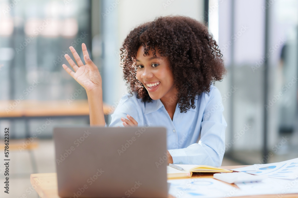 Beautiful businesswoman having video call on laptop computer in office.