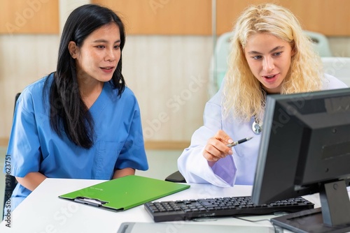 Young female doctor discus with lady patient on healthy problem at hospital clinic
