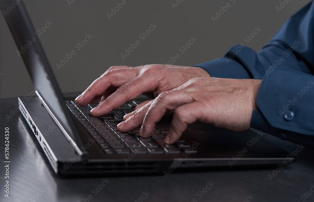 Man's hands typing on laptop Man's hands typing on laptop
