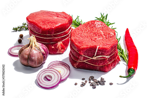 Raw Ribeye steak with spices and herbs isolated on white background. Trendy hard light, dark shadow