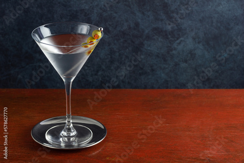 Classic Gin or Vodka Martini Cocktail Shaken with a Garnish of Olives on A Wooden Bar