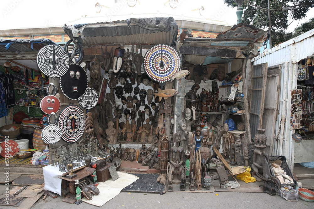 African traditional national folk masks, souvenirs for sale in street market in Africa. Shop, store with vintage african masks in Dakar city, Senegal. African handicraft, craft. African decorative art