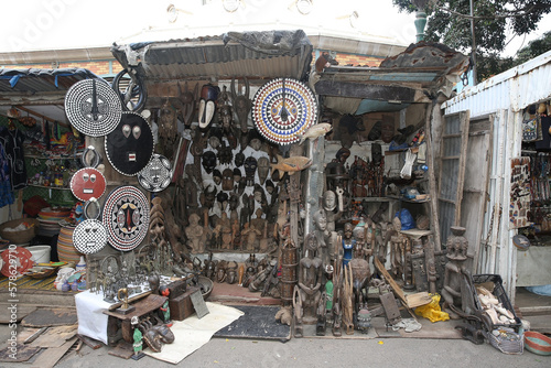African traditional national folk masks  souvenirs for sale in street market in Africa. Shop  store with vintage african masks in Dakar city  Senegal. African handicraft  craft. African decorative art